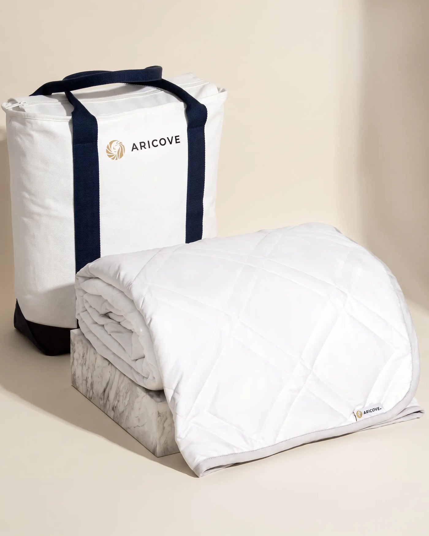 Aricove weighted blanket in full size, rolled beside the Aricove travel bag